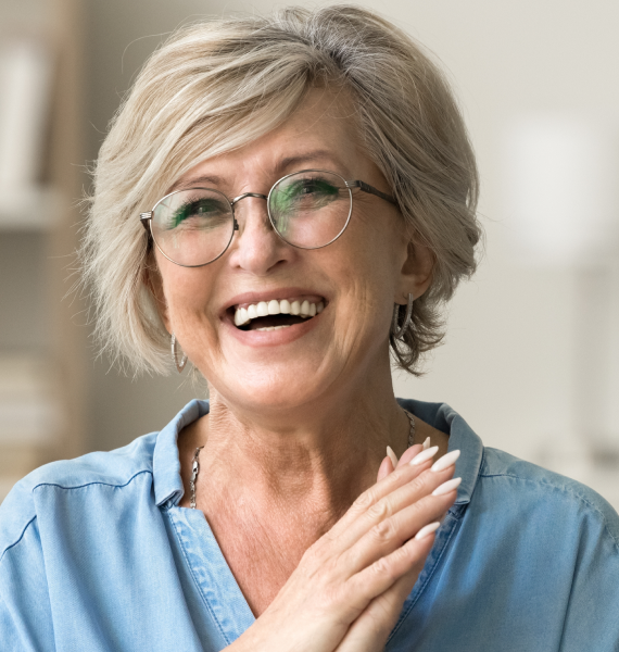 Smiling woman outside with healthy teeth